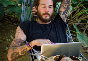Man in hammock with a laptop